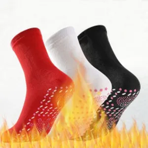 Comfortable thermal socks with dotted soles in red, white and black for cozy daily winter wear.