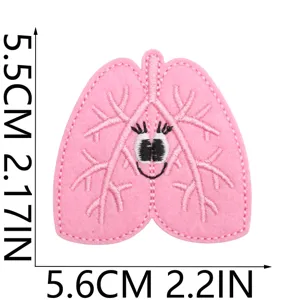 Cute pink lung organ embroidered patch detail, fabric badge with cute smiling face.