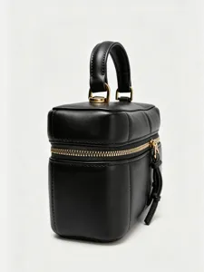 Close-up detail view of the black leather vanity box bag featuring gold-tone hardware and handle.