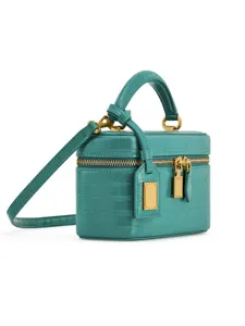 Close-up detail of the turquoise crocodile embossed leather mini vanity box bag gold hardware.