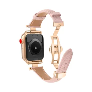 Pink leather apple watch band with metal butterfly buckle detail, elegant replacement strap.