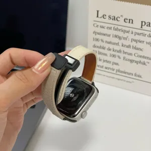Close-up detail of contrast color leather magnetic watch strap showing magnetic buckle.