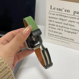 Close-up of green and brown leather magnetic watch strap detail, premium texture and stylish.