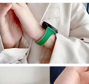 Detail view of the vibrant green leather watch strap worn gracefully on wrist with blazer.