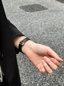 Slim leather watch band compatible with Apple Watch, stylish metal buckle strap for women.