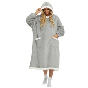 Oversized wearable blanket hoodie detail, grey fleece fabric with cozy pockets and plush hood.