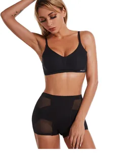 Detailed view of high-waisted black shaping underwear with breathable mesh panels and bra.