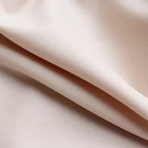Close-up detail shot of smooth and elastic nude fabric, soft texture material preview.