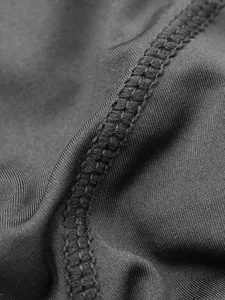 Close-up fabric detail showing durable four-needle stitching of shapewear, high elasticity.