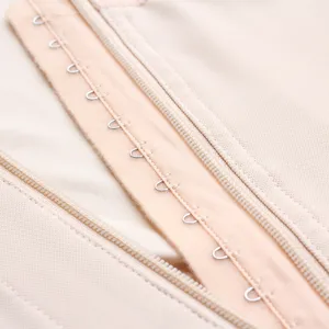 Close-up detail view of nude shapewear featuring durable metal hooks and smooth zipper closure.