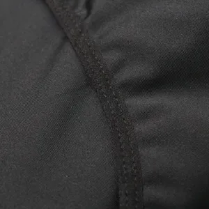 Close-up detail of black stretch shapewear fabric and neat stitching craftsmanship.
