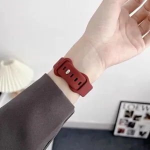 Silicone watch strap detail shot in dark red color showing the texture and buckle design.