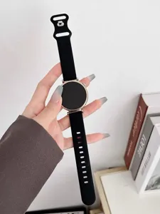 Black silicone smartwatch band with rose gold round case, sleek and modern accessory.