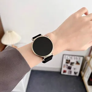 Smartwatch silicone replacement strap detail view, elegant black band with golden metal case.