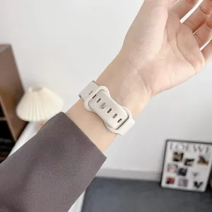 Detail shot of a stylish white wavy silicone smartwatch strap worn on wrist, soft texture.