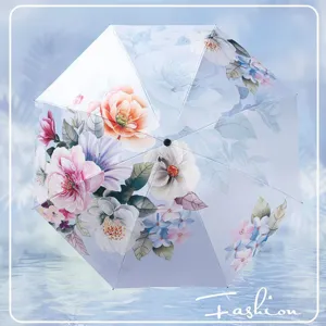 Double-sided printed floral folding umbrella with UV protection for sunny rainy days.