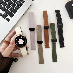 Close-up detail of genuine leather smartwatch straps in multiple colors with magnetic clasp.
