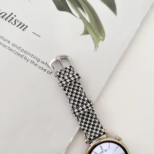 Black and white houndstooth fabric watch strap detail, premium textile replacement band.