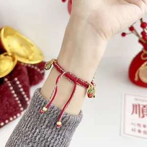 Red braided Apple Watch strap with festive metal charms for stylish smartwatch wristband