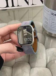 Gedetailleerd overzicht van grijze suède horlogeband voor Apple Watch, zachte textuur, elegant.