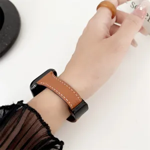 Detail shot of brown lychee pattern leather watch strap compatible with Apple Watch, elegant stitching.