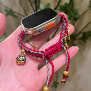 Handmade red braided watch strap compatible with Apple Watch, featuring lucky gourd charms.
