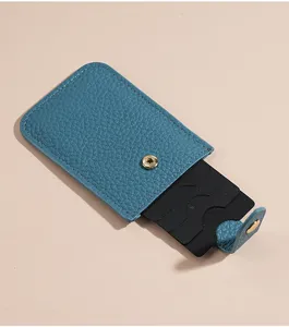 Compact blue leather card holder with pull-out design and snap button for daily portable use.