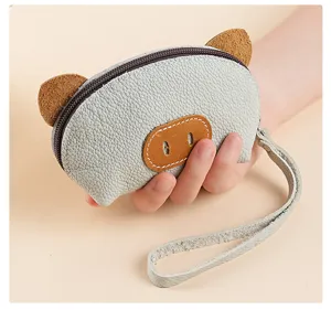 Detailed view of cute pig leather coin purse with zipper and wrist strap for daily use.