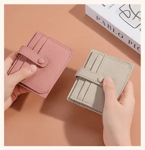Detailed view of genuine leather card holder wallet showing multi-card slots and secure snap closure.