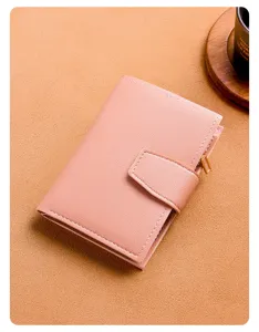Compact trifold women wallet detail showing multi card slots, snap buckle and zipper coin pocket.