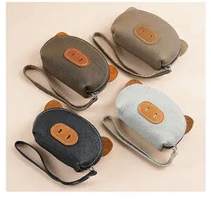Cute leather coin purse for women, mini portable key pouch and card holder with wrist strap.