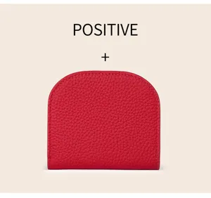 Red genuine leather mini wallet detail showing soft top layer cowhide texture and shape.