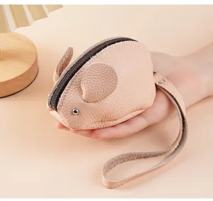 Leather coin purse detail shot, cute mouse design with zipper and wrist strap close-up.