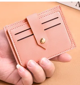 Minimalist pink PU leather card holder with multiple card slots and secure snap button.