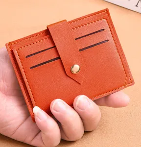 Orange leather card holder detailed view, slim mini credit card case with snap button closure.