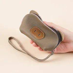 Cute leather pig coin purse for women, mini zipper pouch with wrist strap for keys.