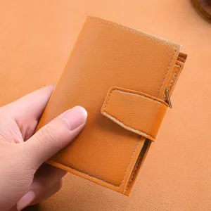 Compact brown leather trifold wallet for women with snap closure and multi card slots.