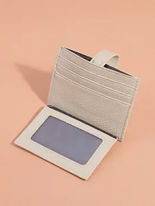 Minimalist leather card holder with multiple slots and clear ID window for daily use.