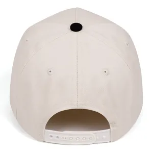 Back view of a plain beige snapback baseball cap with black button and white strap.