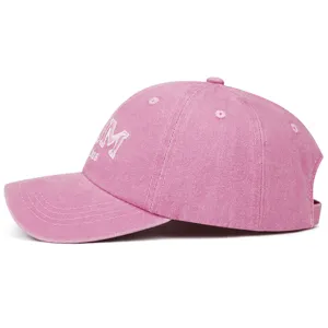 Pink washed dad mom baseball cap detail view showing vintage embroidery and curved brim design.