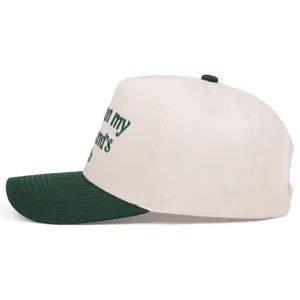 Side detail view of the embroidered contrast baseball cap featuring green text and visor.