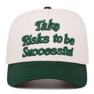Close-up detail of the 3D green embroidered motivational text on white baseball cap front.