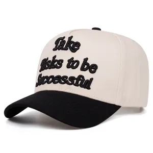 Detailed view of the black and beige baseball cap featuring bold 3D embroidered lettering.