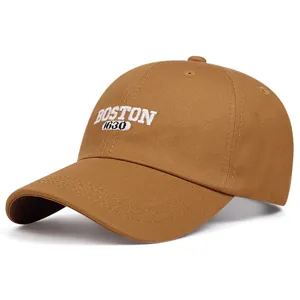 Close-up view of the brown baseball cap showcasing detailed front embroidery and soft crown fabric.