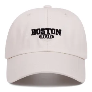 Detailed front view of a beige embroidered baseball cap with Boston 1630 lettering.