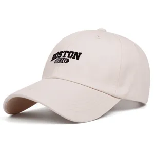 Beige baseball cap detail shot, embroidered Boston text, casual curved brim street hat.