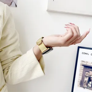 Detailed close-up view of the golden metal mesh smartwatch strap showcasing fine craftsmanship.