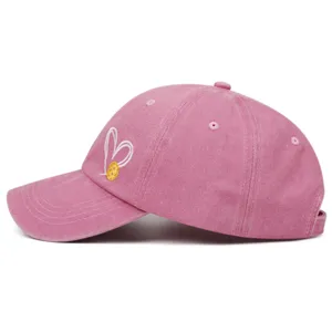 Pickleball heart embroidery baseball cap detail, pink washed denim casual dad hat closeup.