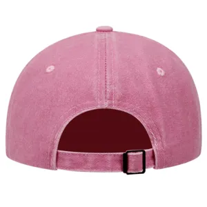 Pink washed baseball hat detail view, retro cotton dad cap with adjustable metal buckle strap.