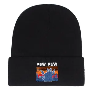 Detailed view of the black knit beanie featuring a fun embroidered cat and retro sunset design.